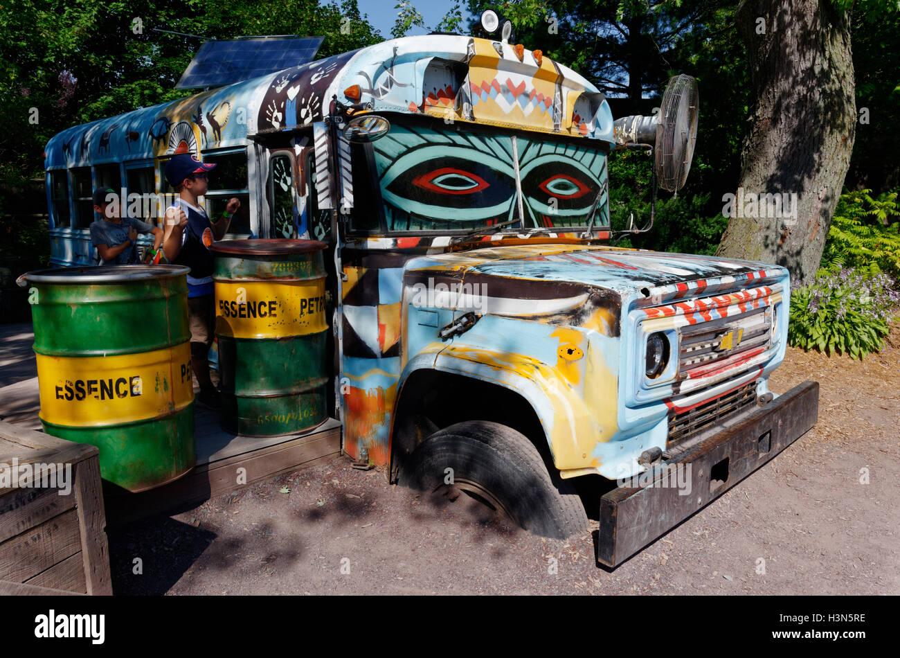An old bus painted in many colours at Granby Zoo in Quebec Stock Photo