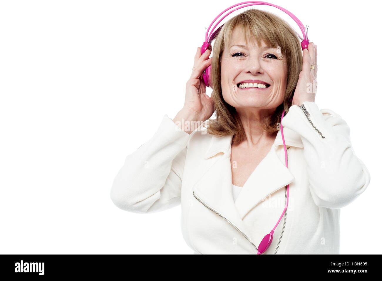 Smiling woman enjoying music Cut Out Stock Images & Pictures - Alamy