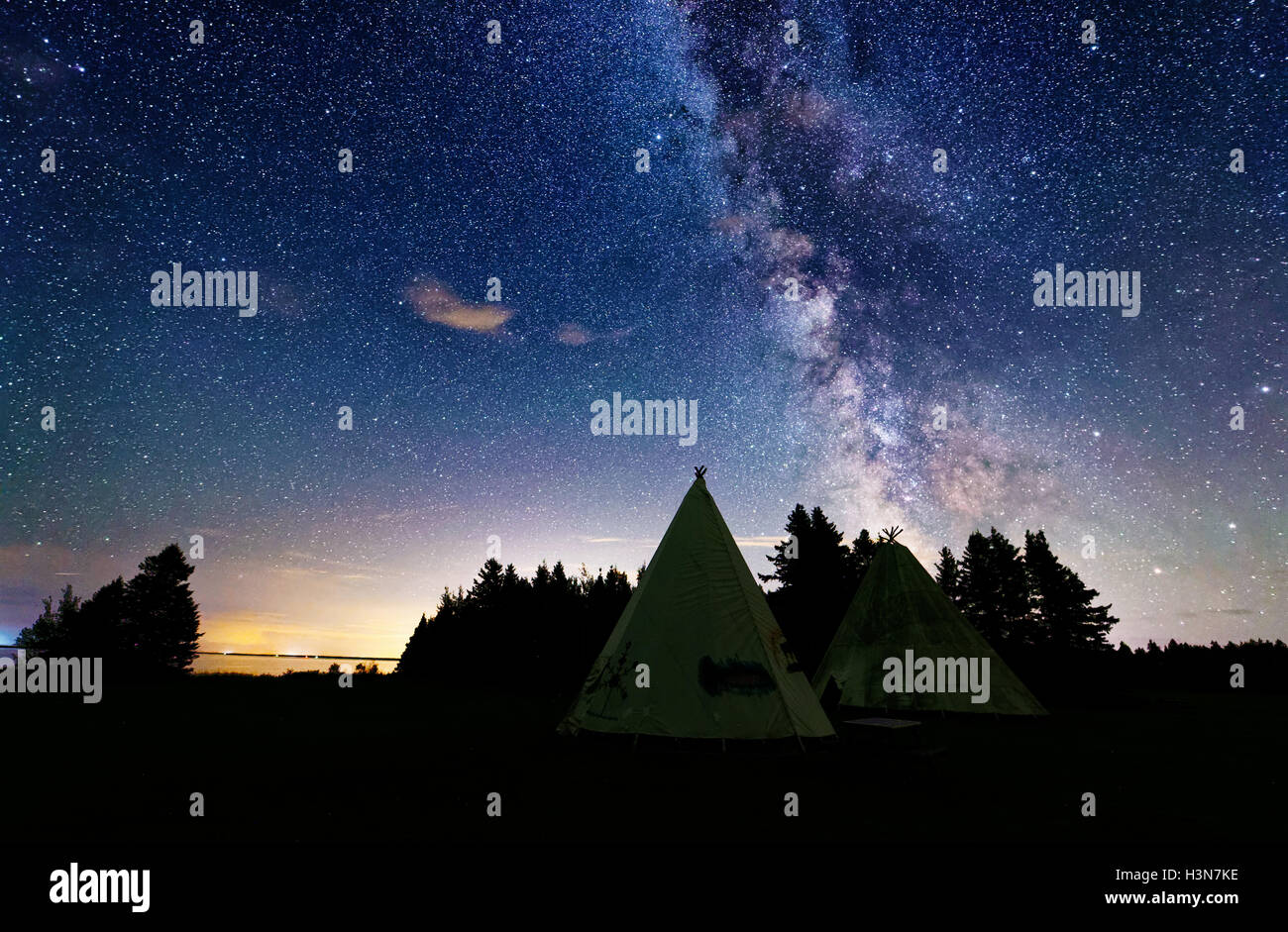 Wigwams and the Milky Way in dark skies in Kouchibouguac National Park in New Brunswick, Canada Stock Photo