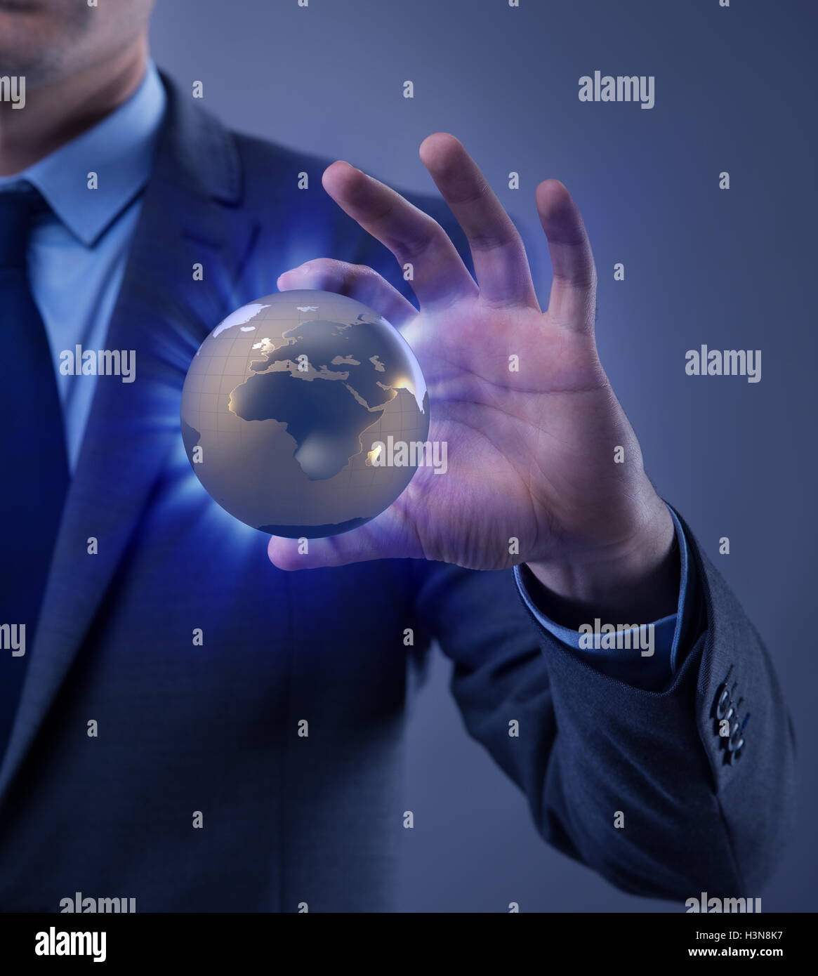 Businessman holding globe in global business concept Stock Photo - Alamy