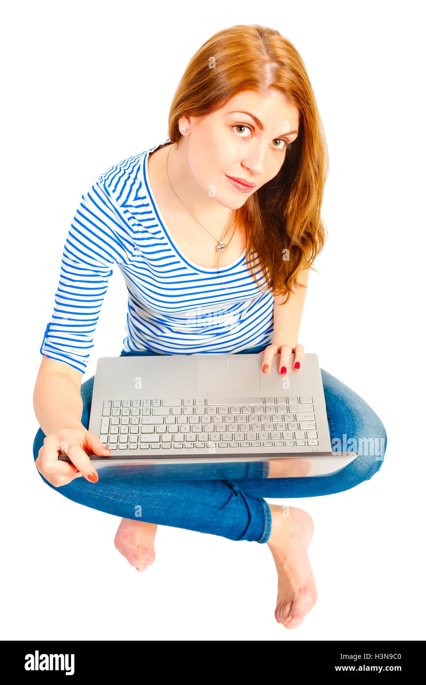 a charming young girl on a white background with a laptop Stock Photo ...