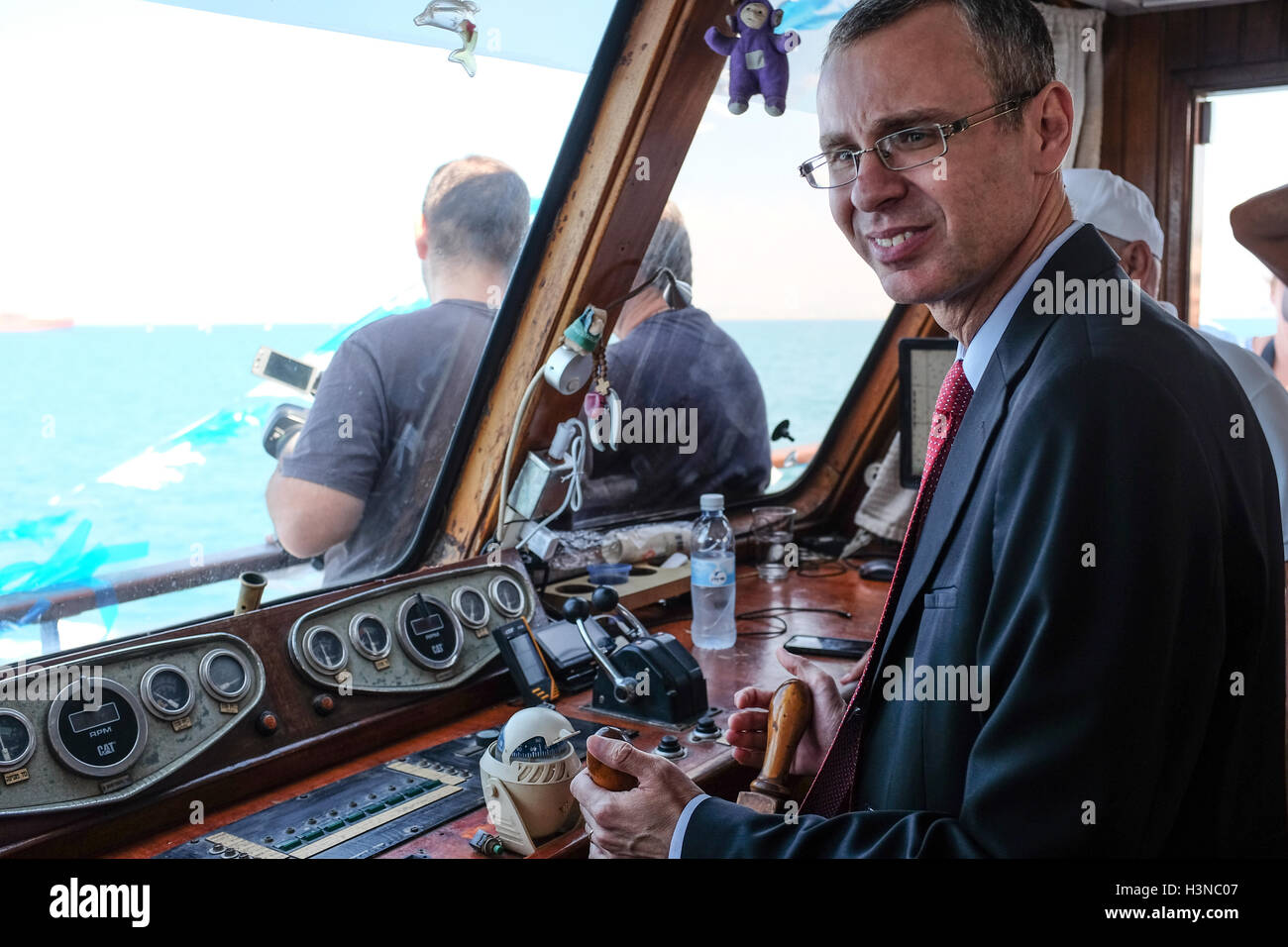 Israel. 10th October, 2016. Israeli Tourism Minister YARIV LEVIN pilots the 'Acre Queen' on its inauguration cruise launching the Haifa-Acre pleasure cruise line. The line, which will run on a fixed timetable with several daily cruises, is aimed at domestic and international tourism offering views of the Carmel Mountains, downtown Haifa, along the coast, the colorful and authentic fishing port in Acre and the Acre Marina. Credit:  Nir Alon/Alamy Live News Stock Photo
