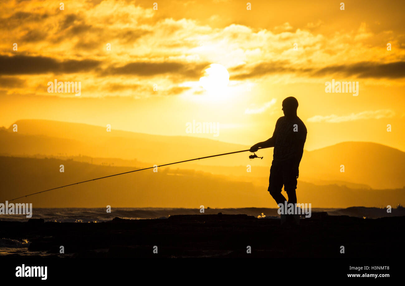 Las Palmas, Gran Canaria, Canary Islands, Spain. 11th Oct, 2016. Weather : A fisherman silhouetted against the setting sun near Las Palmas at the end of a glorious day on Gran Canaria. Credit:  Alan Dawson News/Alamy Live News Stock Photo