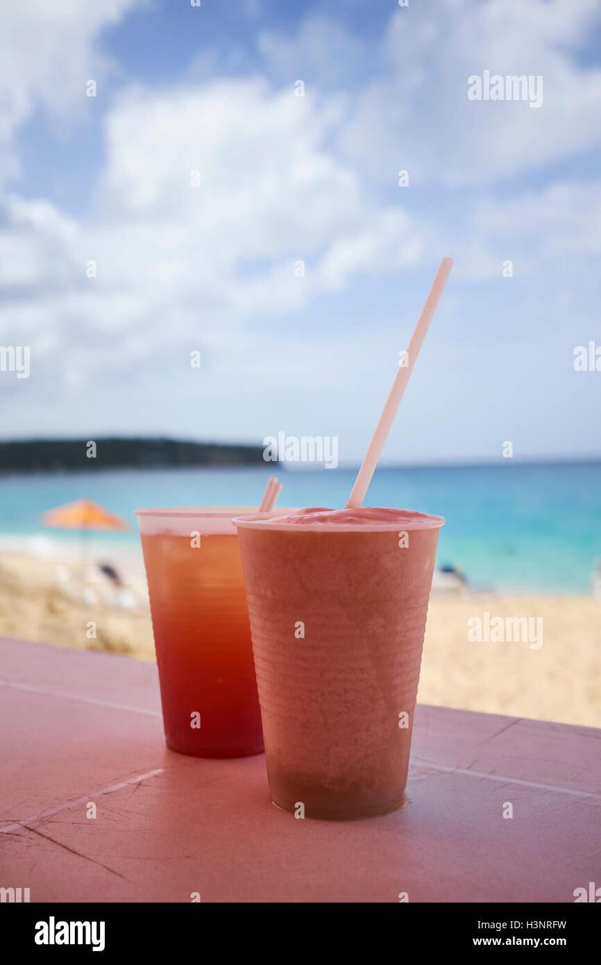 Cups of cold drink, beach in background Stock Photo
