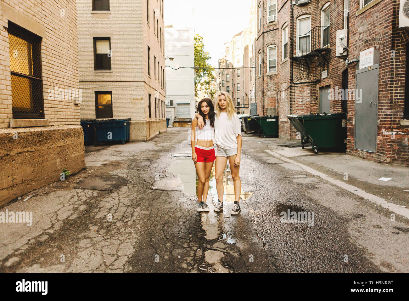 Women standing near puddle on road, Boston, MA, USA Stock Photo