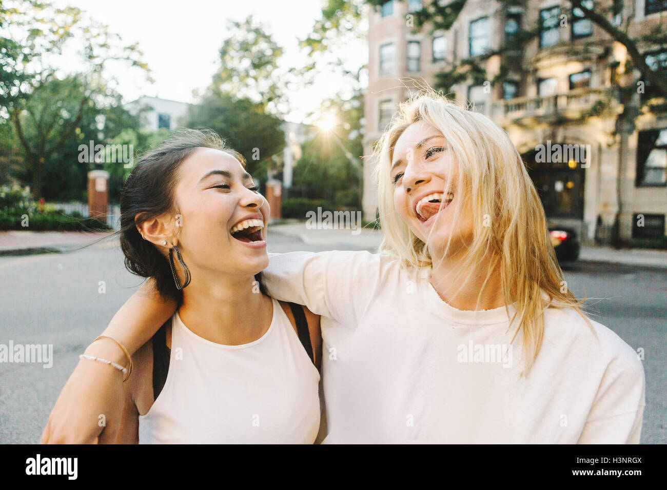 Women laughing on street Stock Photo - Alamy