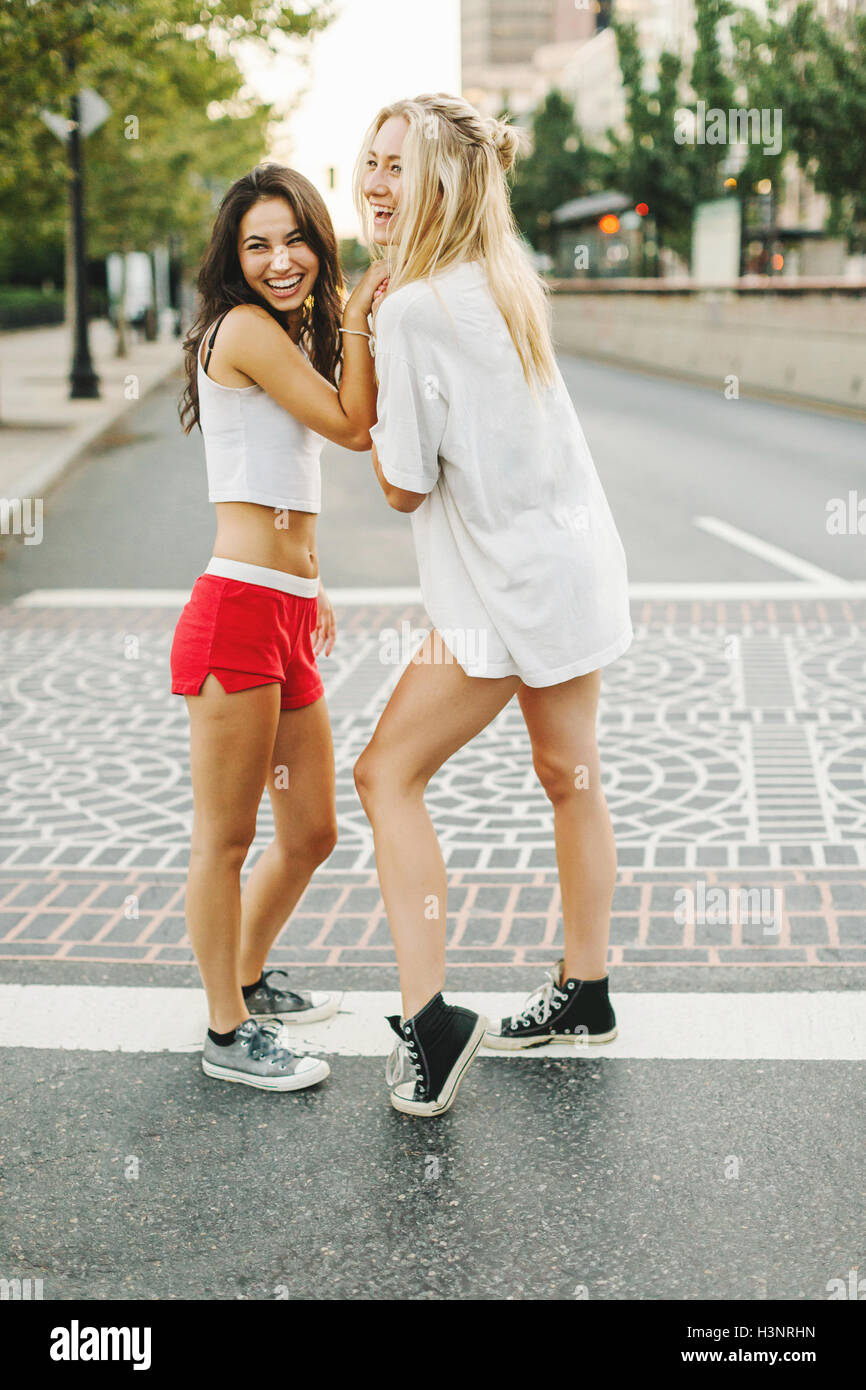 Women laughing on street Stock Photo - Alamy