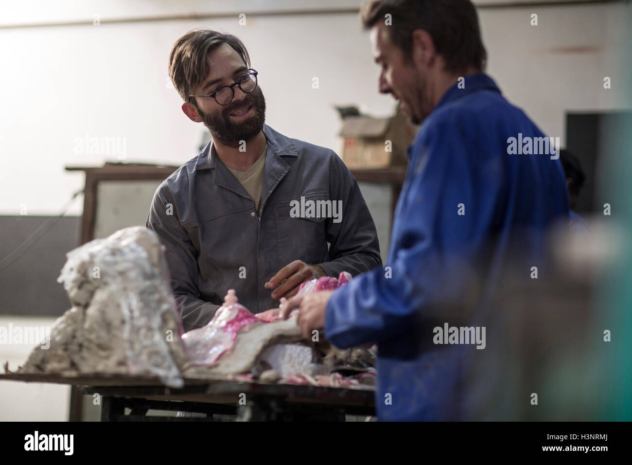 Sculptors in artist studio creating plaster cast sculpture Stock Photo