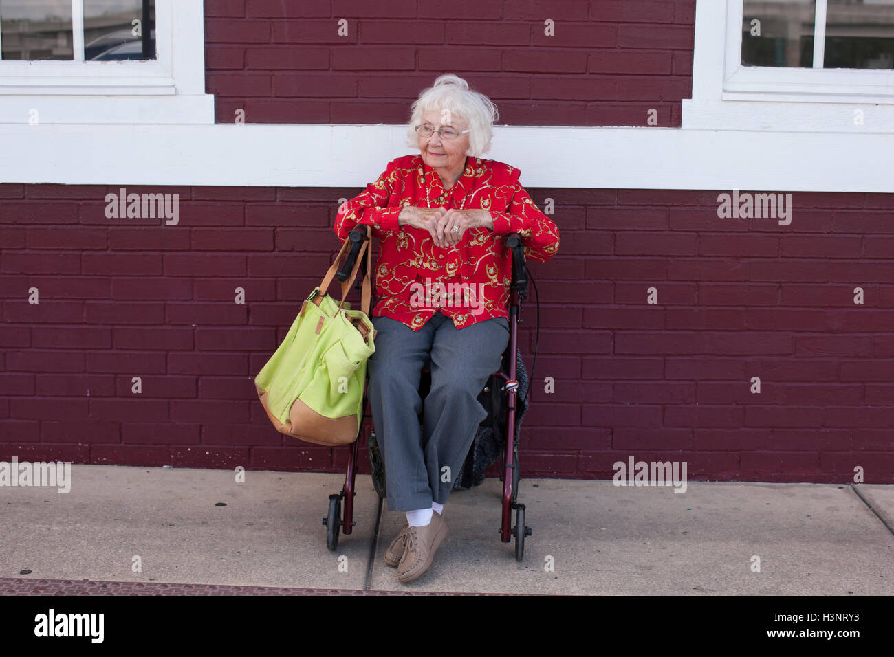 Senior woman sitting in wheelchair, outdoors Stock Photo
