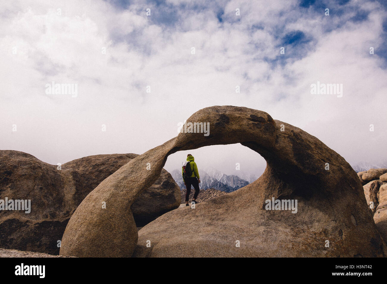 Hiker by natural rock arch, Alabama Hills, Lone Pine, California, USA Stock Photo