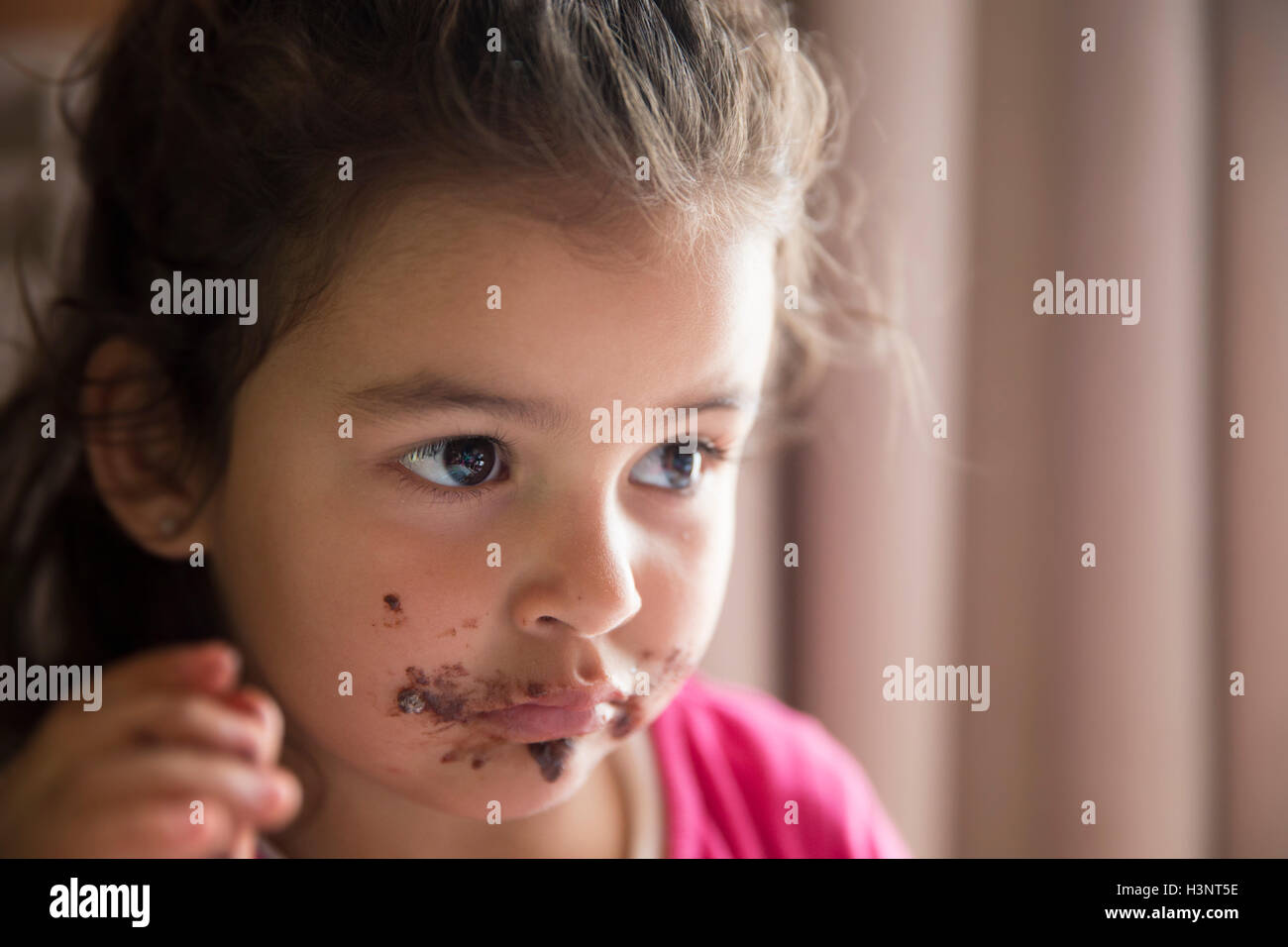 Girl with dirty mouth eating chocolate cookie Stock Photo Alamy
