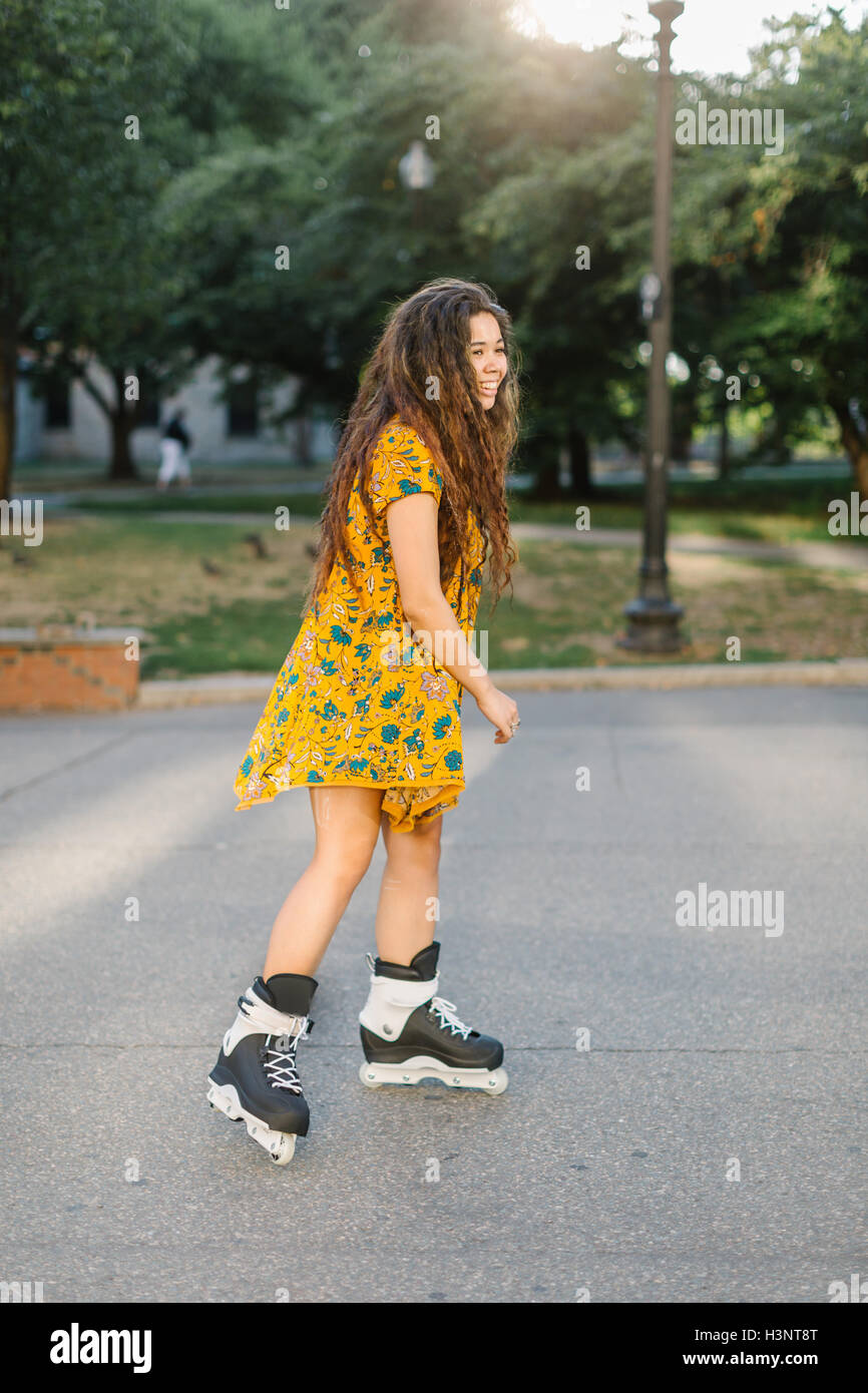 Young woman rollerblading in city park Stock Photo