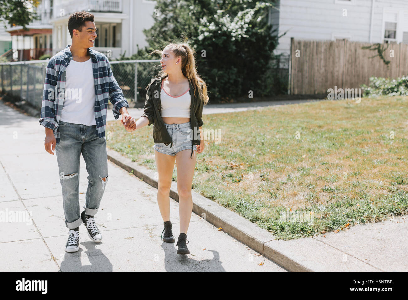 Couple walking in street holding hands Stock Photo - Alamy