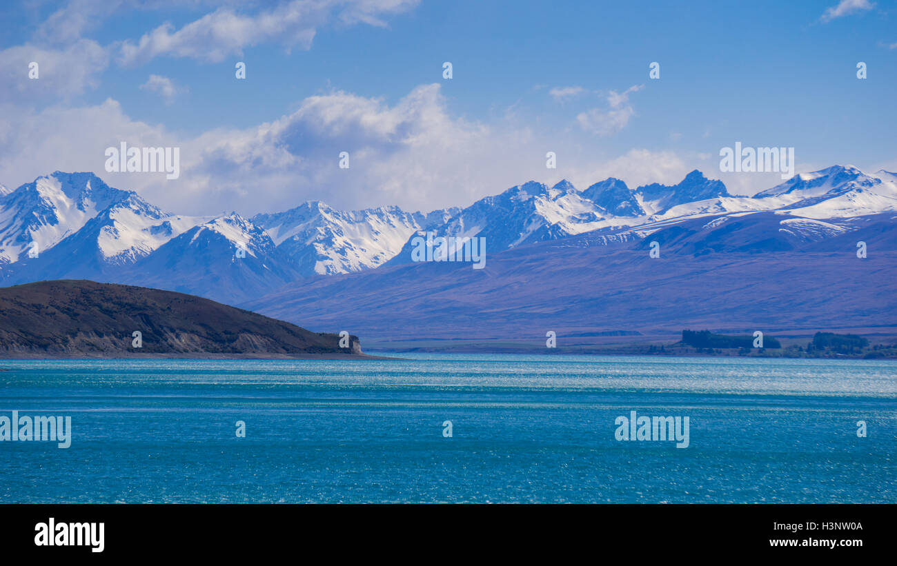 Mountain range and lake with turquoise colored water Stock Photo - Alamy