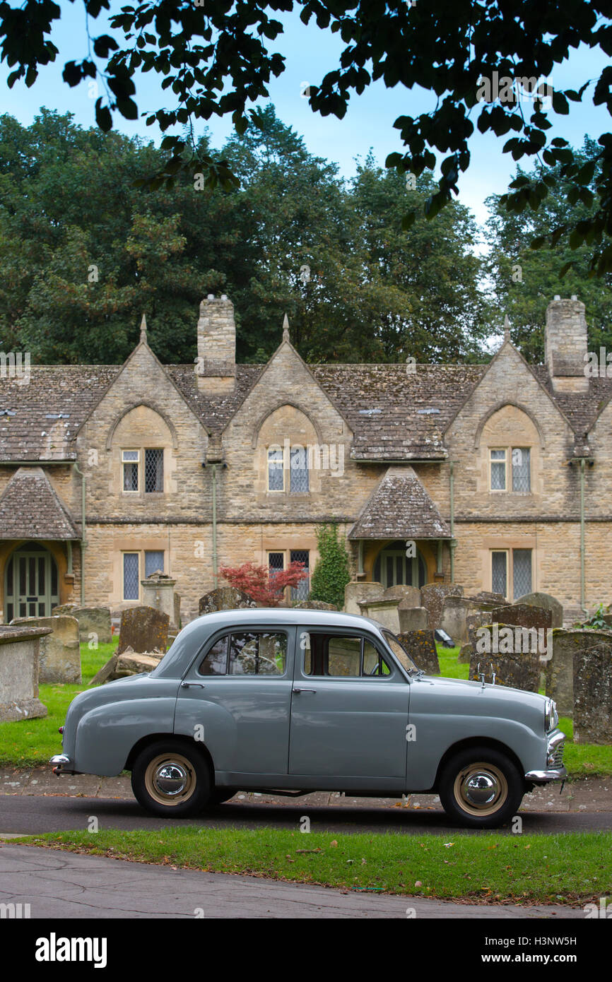 Austin Standard classic car parked outside Holloways Almshouses, St Mary's Church, Witney, Cotswolds, England, United Kingdom Stock Photo