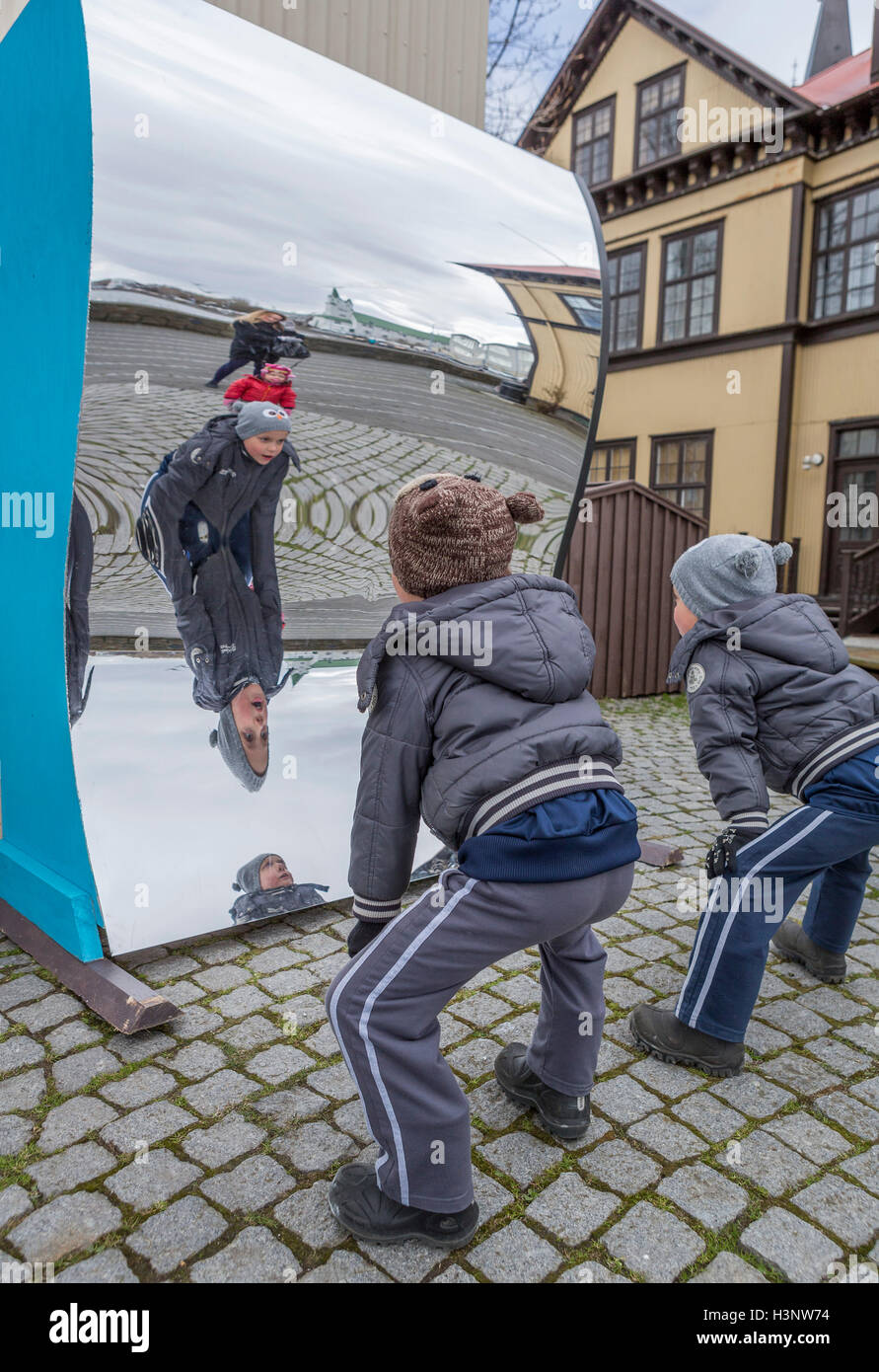 Boys looking in a fun mirror, Children's festival, Reykjavik, Iceland Stock Photo