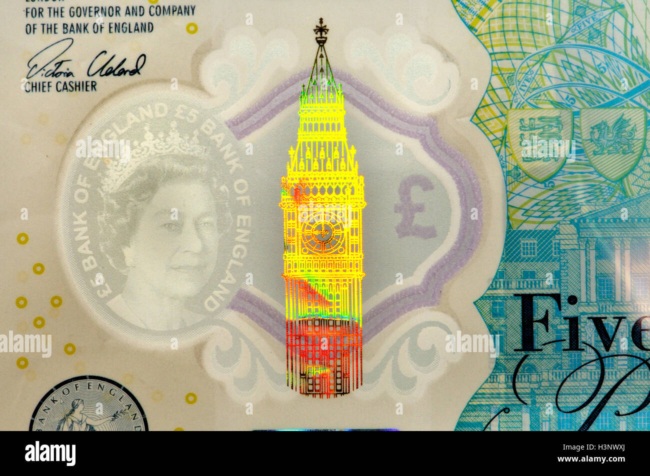 New (2016) British plastic £5 note showing security features: transparent 'watermark'; Big Ben hologram; 'Eurion constellation'. Stock Photo