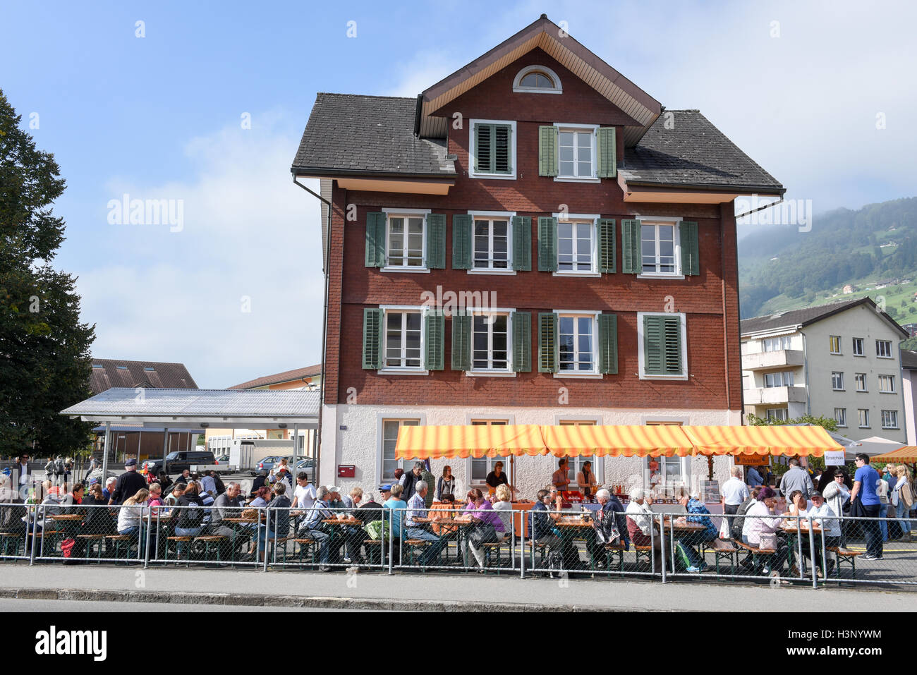 Ennetbuergen, Switzerland - 24 September 2016: People eating and drinking on street restaurants at Ennetbuergen on the Swiss alp Stock Photo
