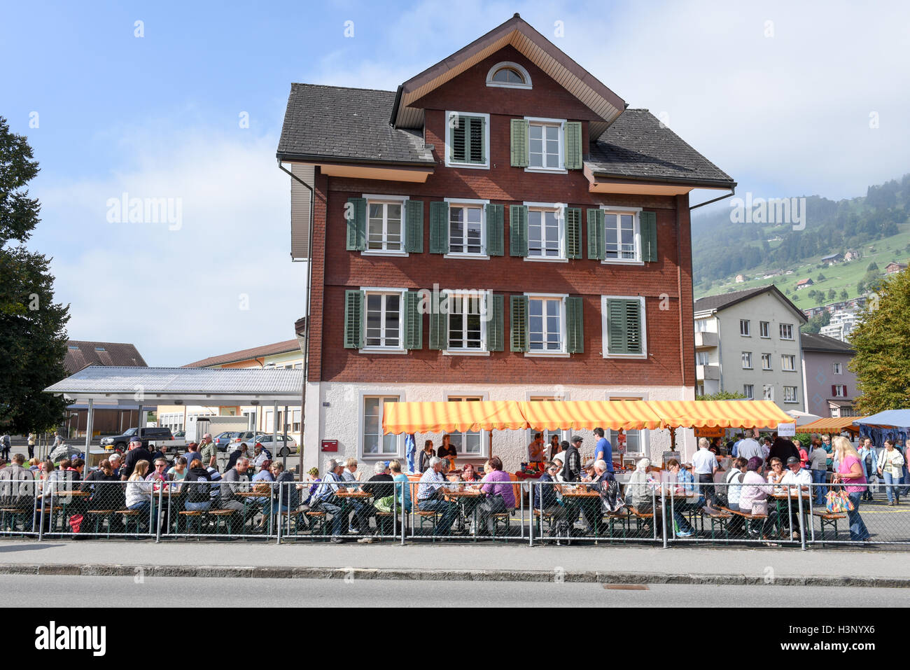 Ennetbuergen, Switzerland - 24 September 2016: People eating and drinking on street restaurants at Ennetbuergen on the Swiss alp Stock Photo