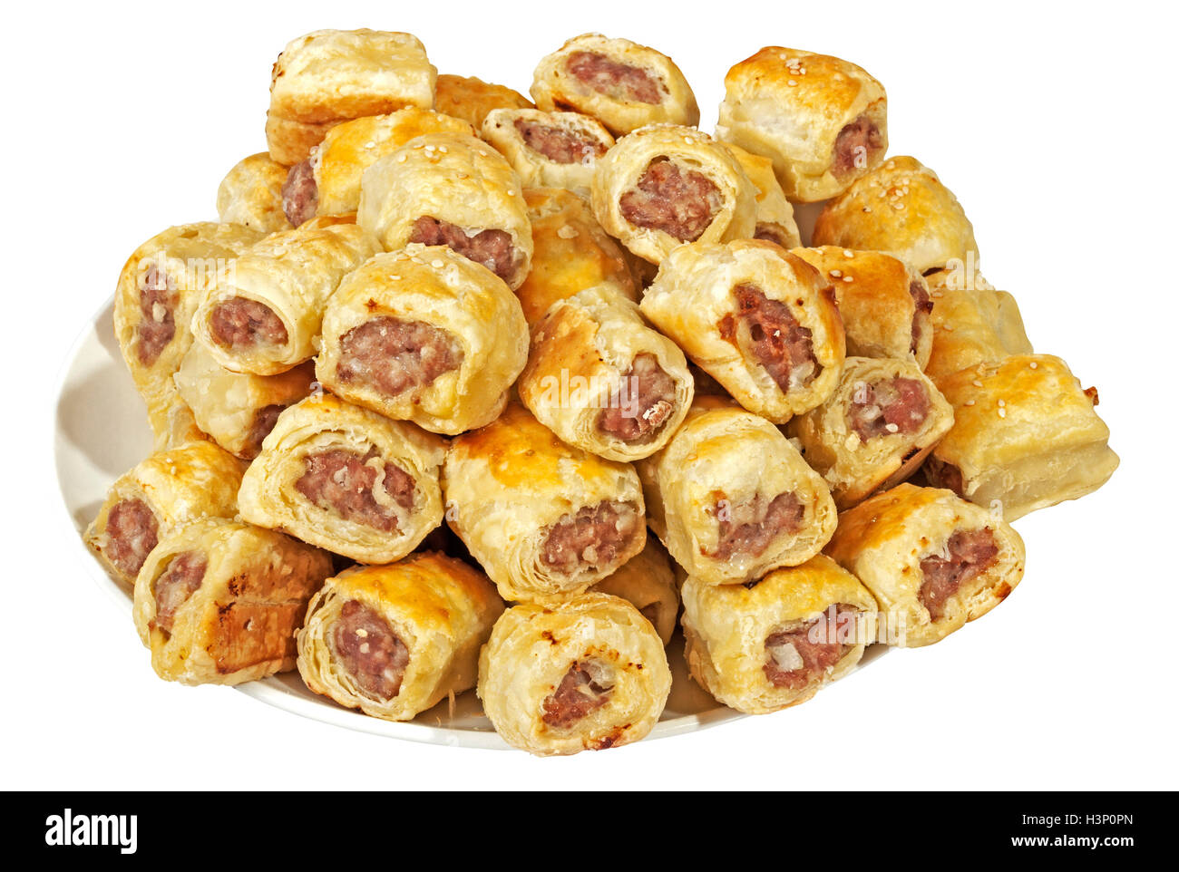 Studio shot of isolated pile of fresh homemade cocktail sausage rolls on white plate Stock Photo