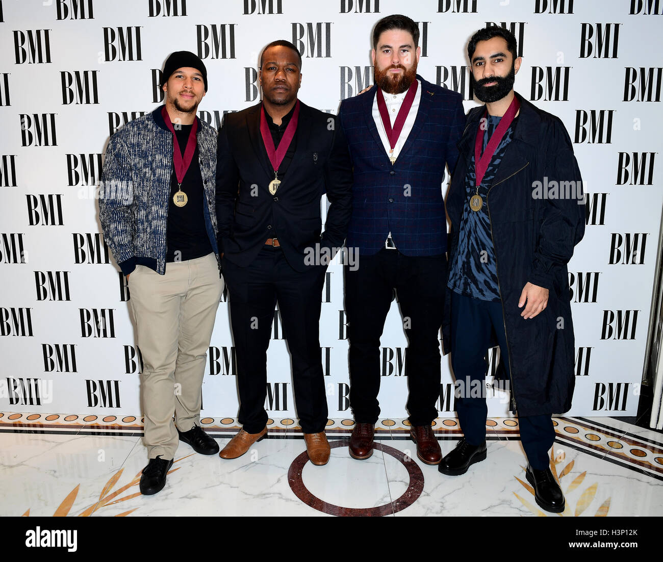 Rudimental's Kesi Dryden (left), DJ Locksmith (second left), Piers Agget (second right) and Amir Amor (right) attending the BMI London Awards at the Dorchester Hotel, London. Stock Photo