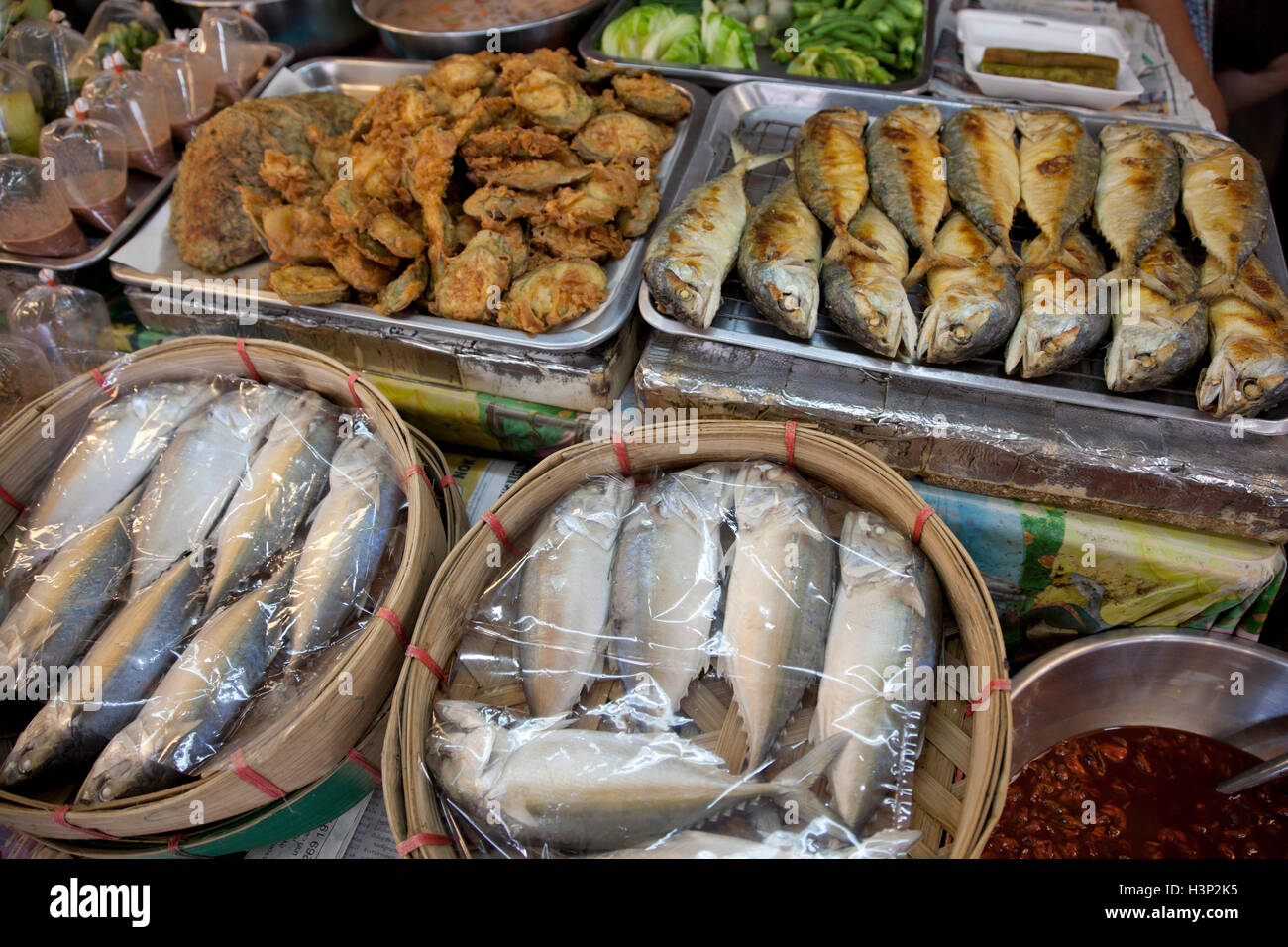Grilled whole fishes and raw fishes and other foodstuffs for salt from a stall at Or Tor Gor market in Bangkok in Thailand. Stock Photo