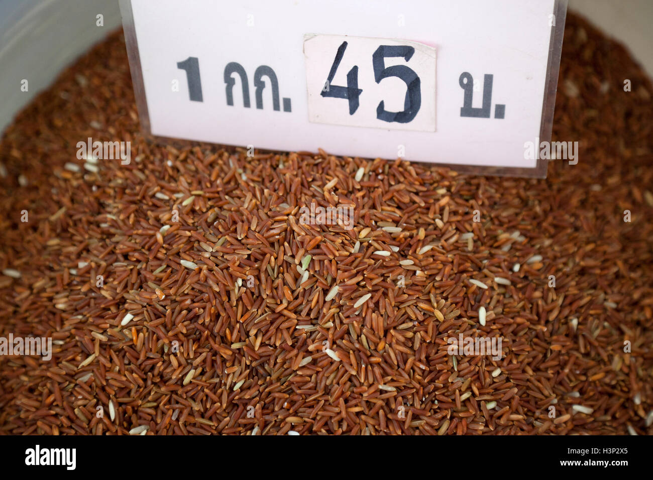 Thai red cargo rice for sale in a market in Bangkok. Stock Photo