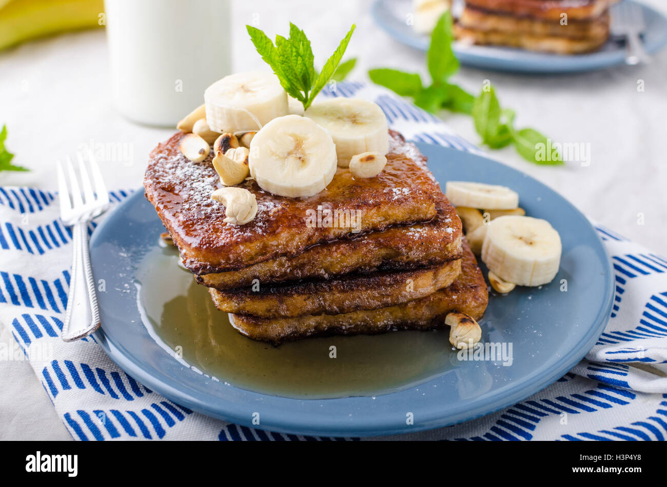 French toast with banana, forest fruit and maple syrup and milk Stock