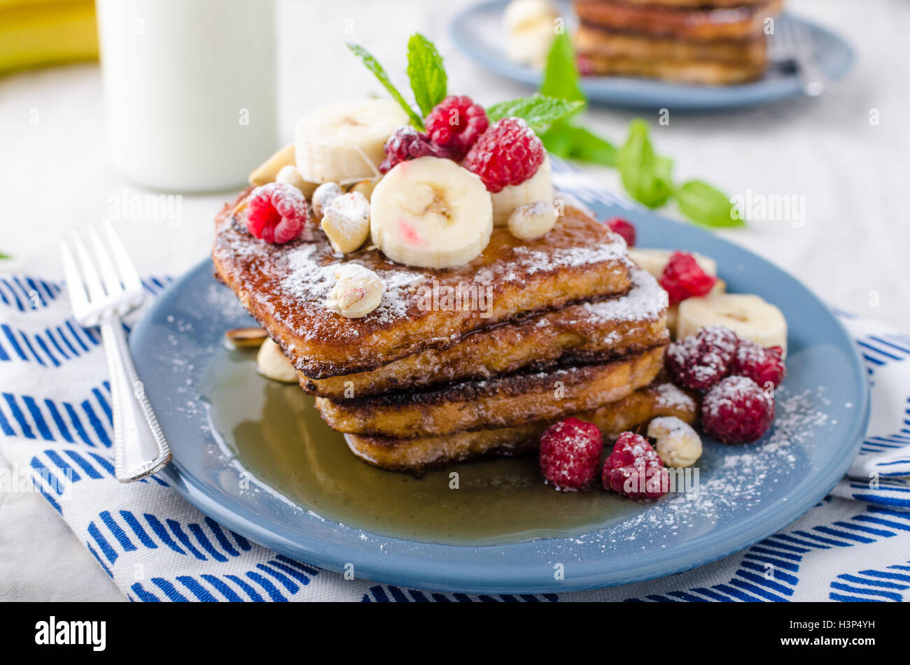 French Toast With Banana Forest Fruit And Maple Syrup And Milk Stock Photo Alamy