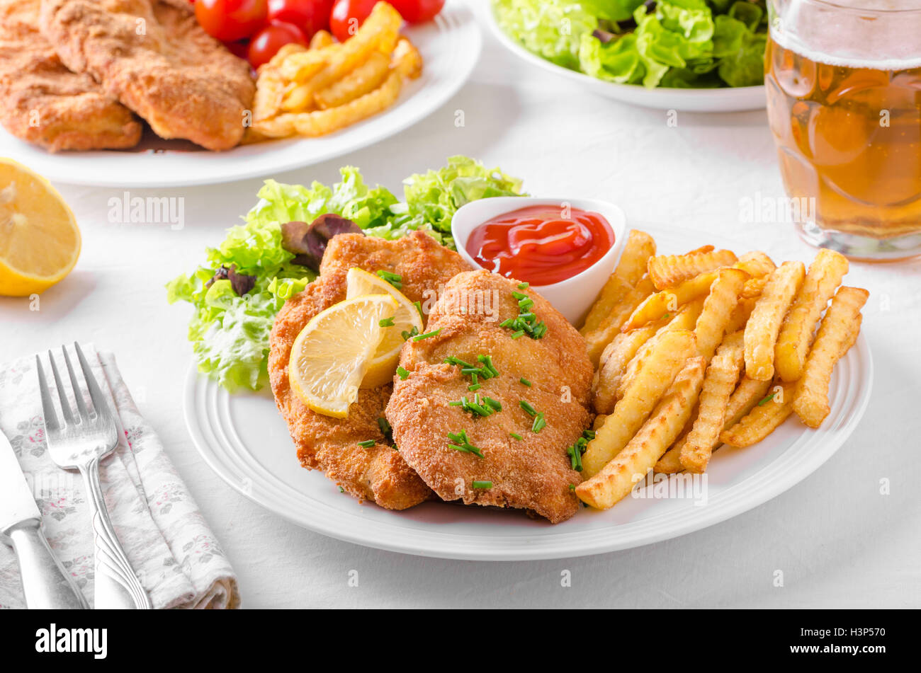 Wiener schnitzel with french fries, salad and a sharp dip Stock Photo ...