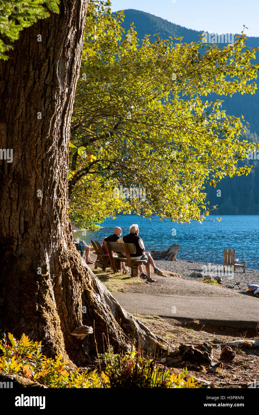 People sitting on bench at Lake Crescent Lodge - Olympic National Park - near Port Angeles, Washington USA Stock Photo