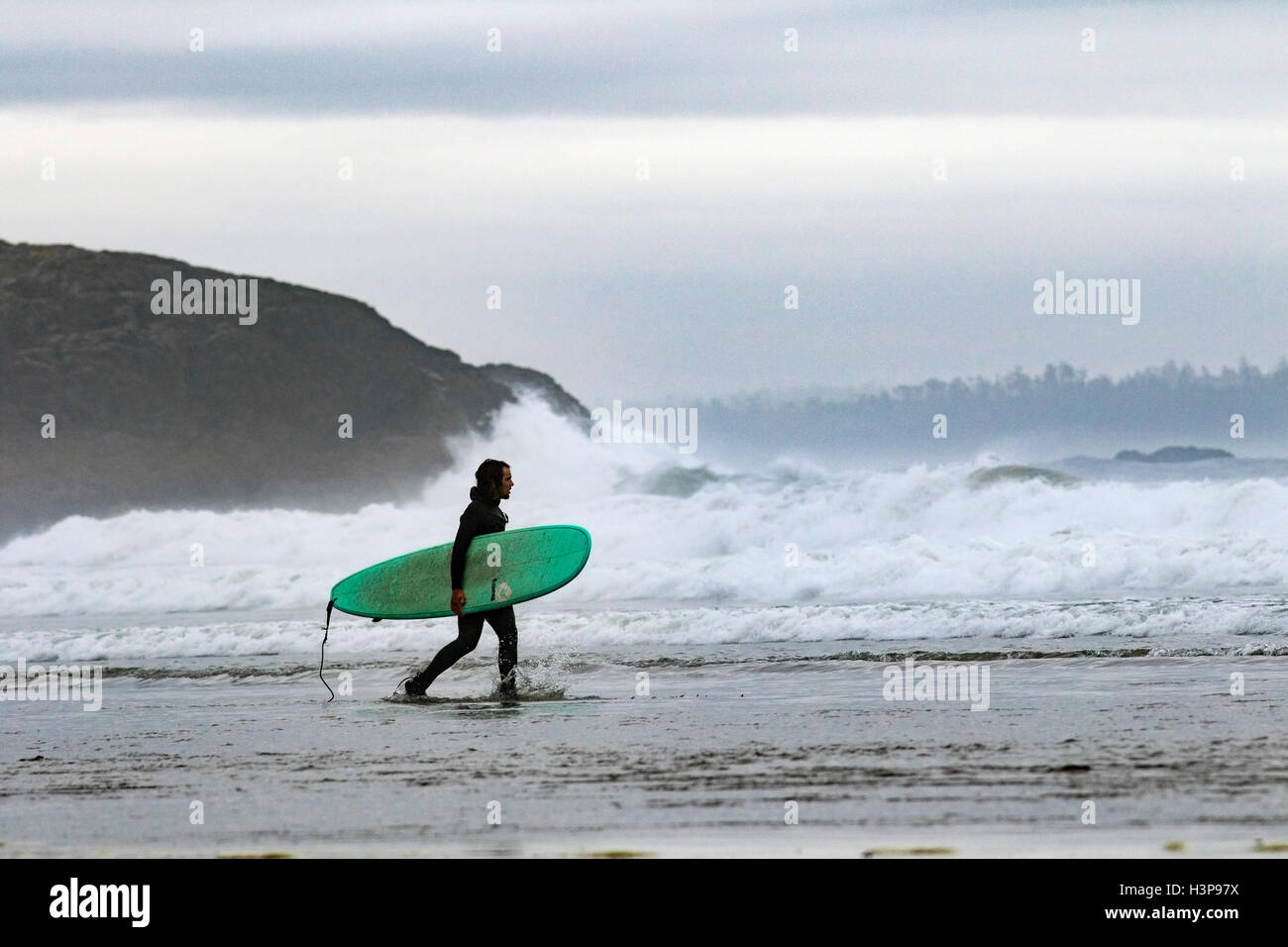 Surfer on Long Beach - Tofino, Vancouver Island, British Columbia, Canada Stock Photo