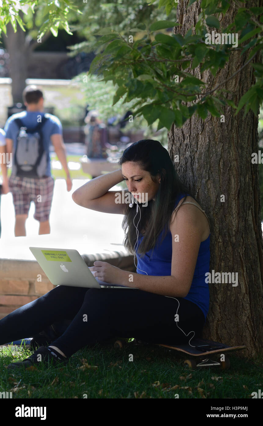 University of Colorado student Selena Martinez studies outside on a warm autumn day Stock Photo