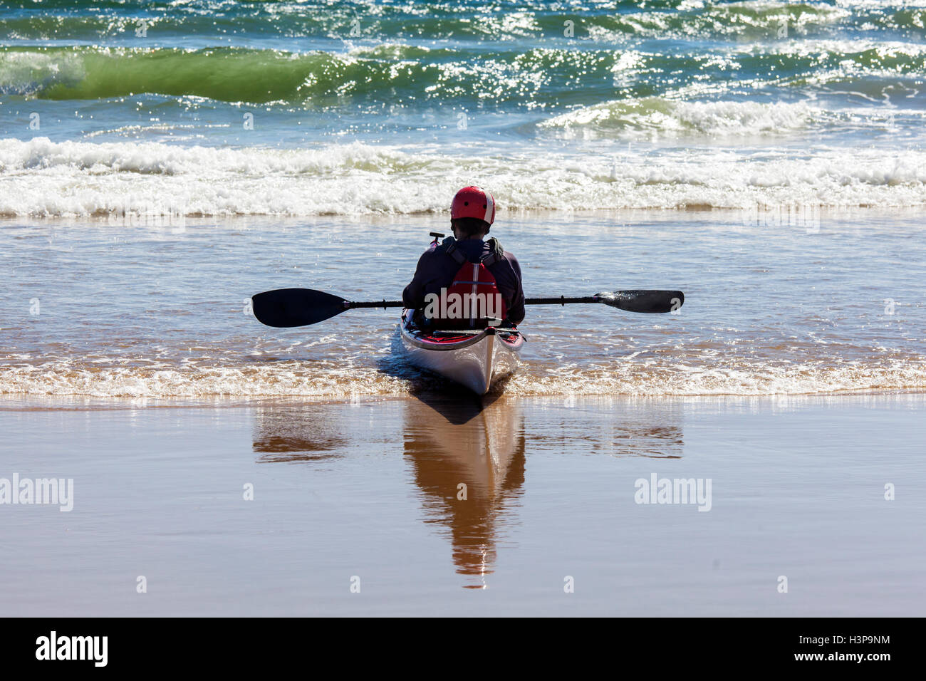 Canoeist waiting for a wave at Tathra Beach Stock Photo