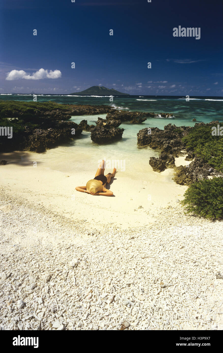 Woman sunbathing on a beach, Stock Photo