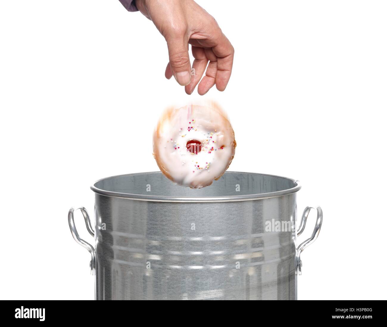 Person throwing cake into dustbin Stock Photo Alamy