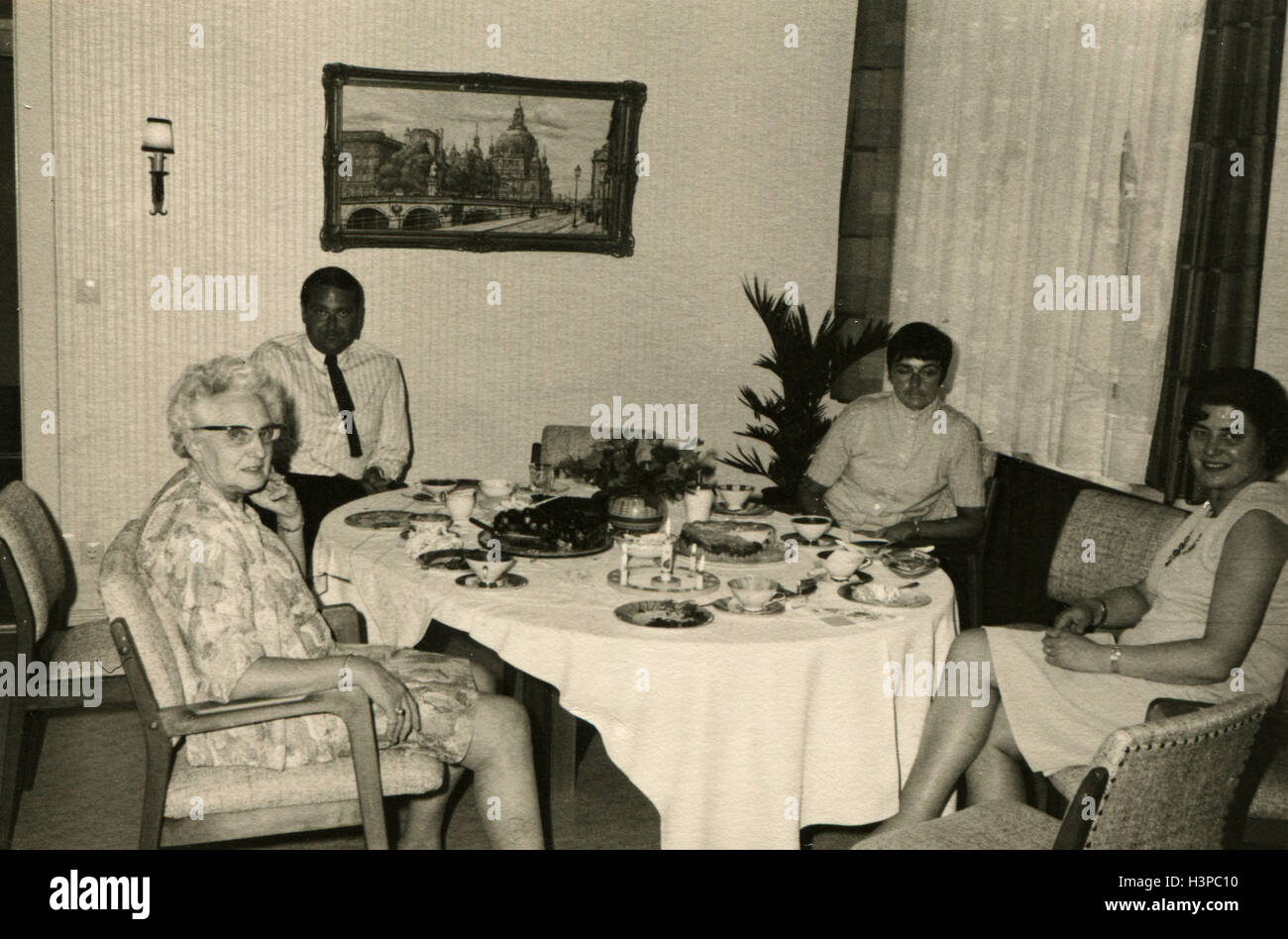 GERMANY - CIRCA 1960s: the family around the table for a festive dinner. Three generations. Stock Photo