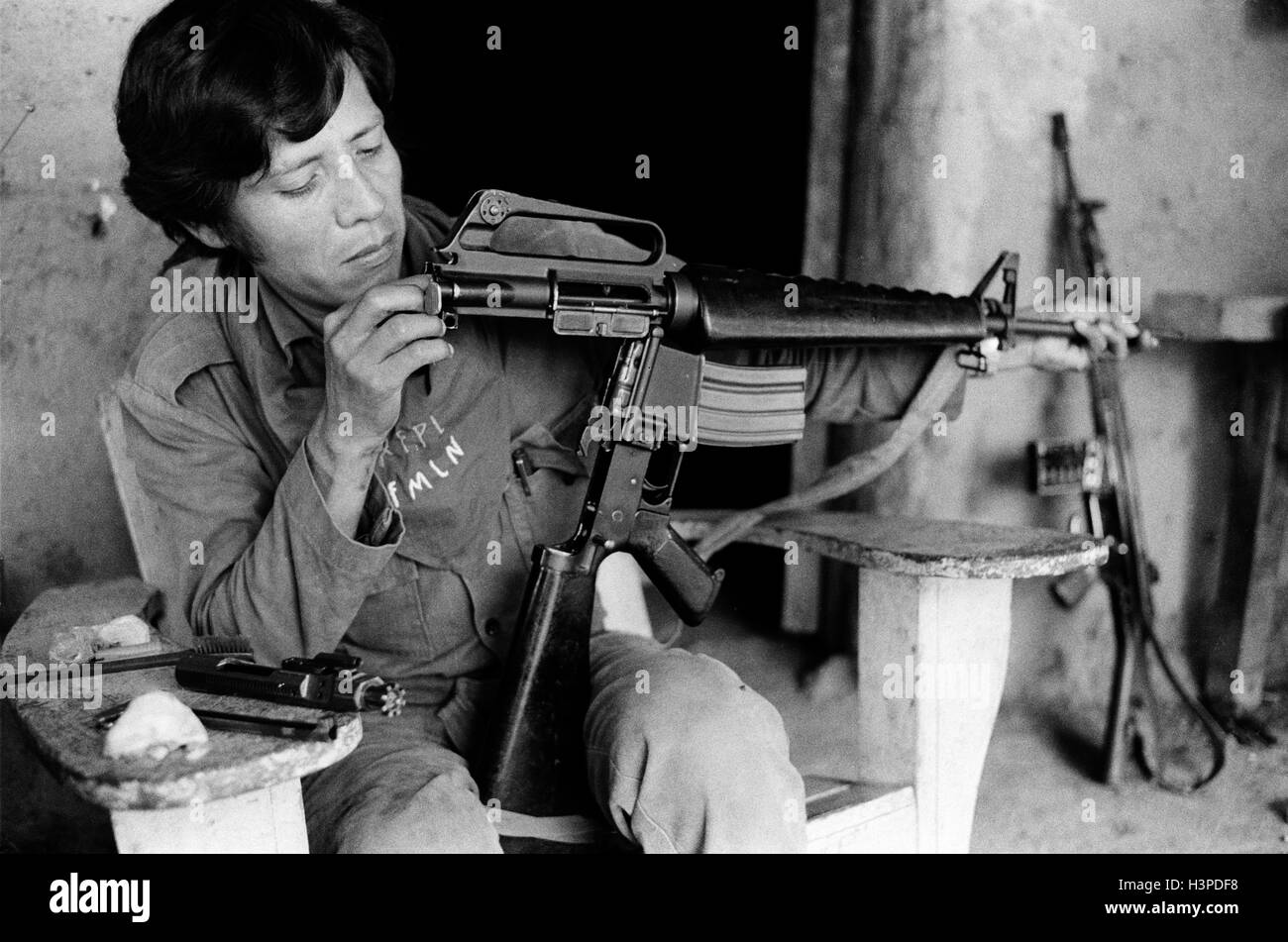CHALATENANGO,   EL SALVADOR, FEB 1984: - Within the FPL Guerrilla's Zones of Control   An FPL fighter cleaning his rifle.   Photo by Mike Goldwater Stock Photo