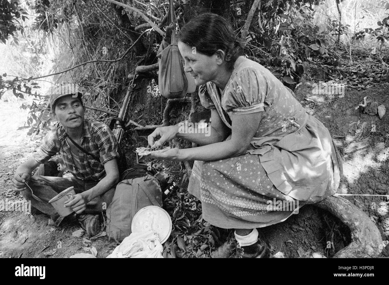 CHALATENANGO,  EL SALVADOR, FEB 1984: - Within the FPL Guerrilla's Zones of Control   A member of the PPL militia in his mother's kitchen Stock Photo