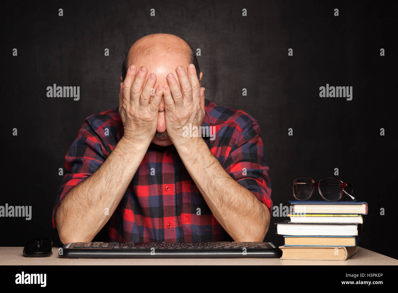Elderly man covered his face with fatigue Stock Photo Alamy