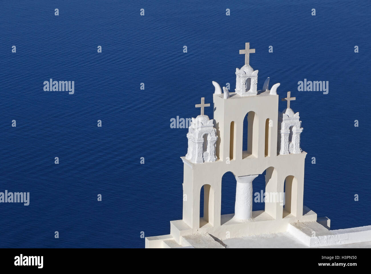 tower with three crosses on church in Firostefani, Greece Stock Photo