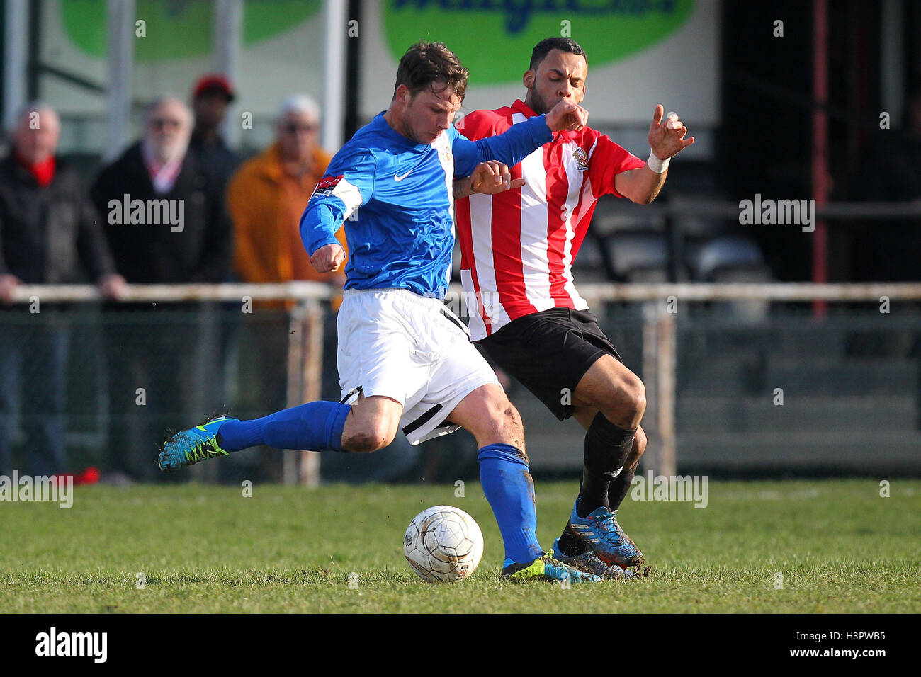Kenny Beaney of Grays clears from Chris Bourne of Hornchurch AFC