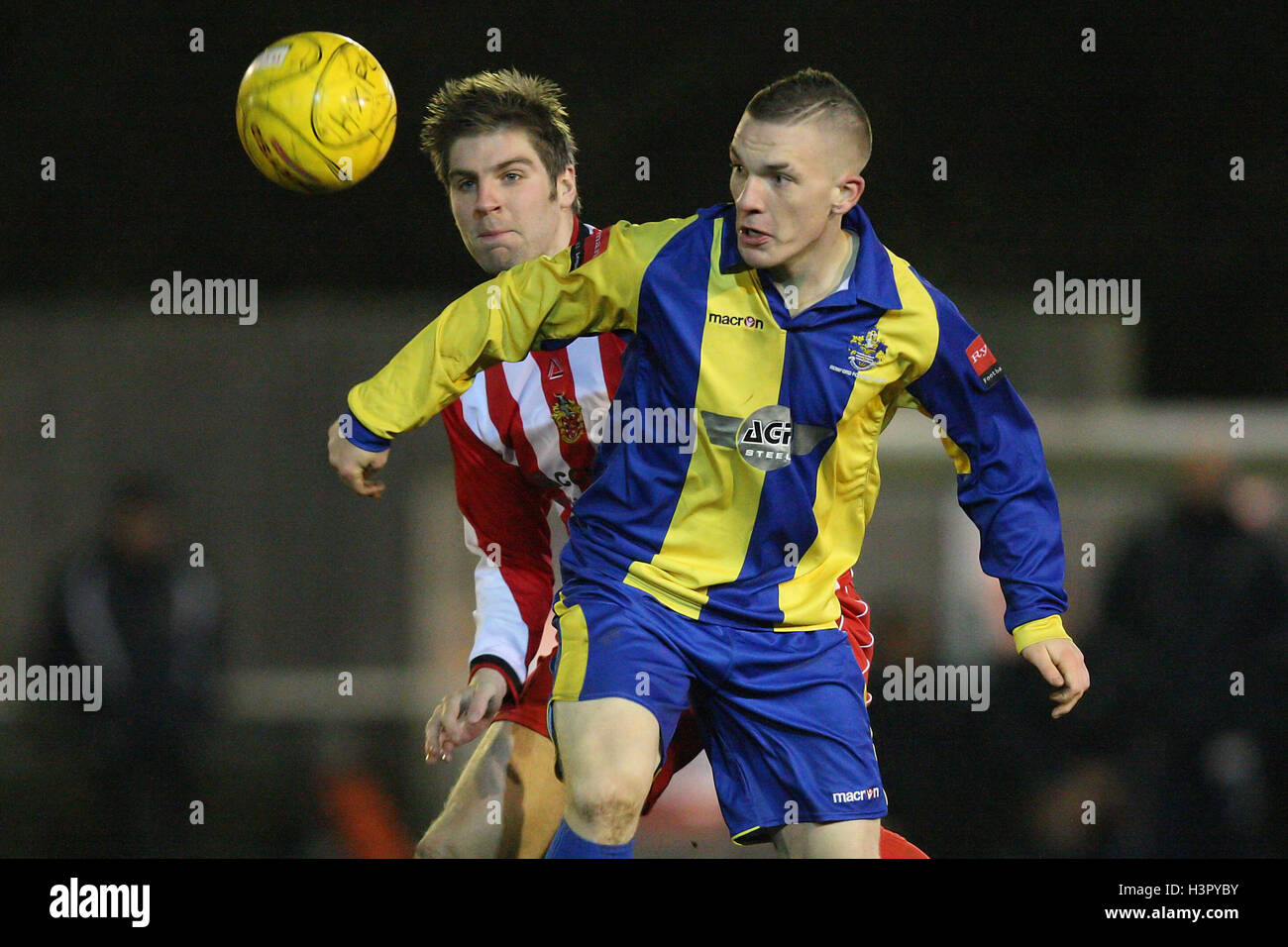 Alex Read of Romford tangles with Ronnie Fletcher of Hornchurch AFC