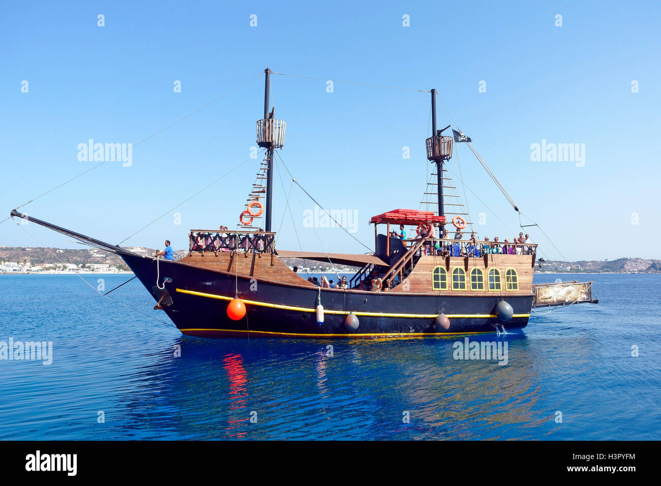 Pirate day trip ship arriving at the harbour at Kefalos Kos, Greece Stock Photo