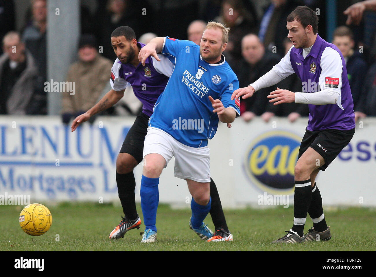 Dave Collis of Billericay seeks to evade Michael Spencer (L) and Martin