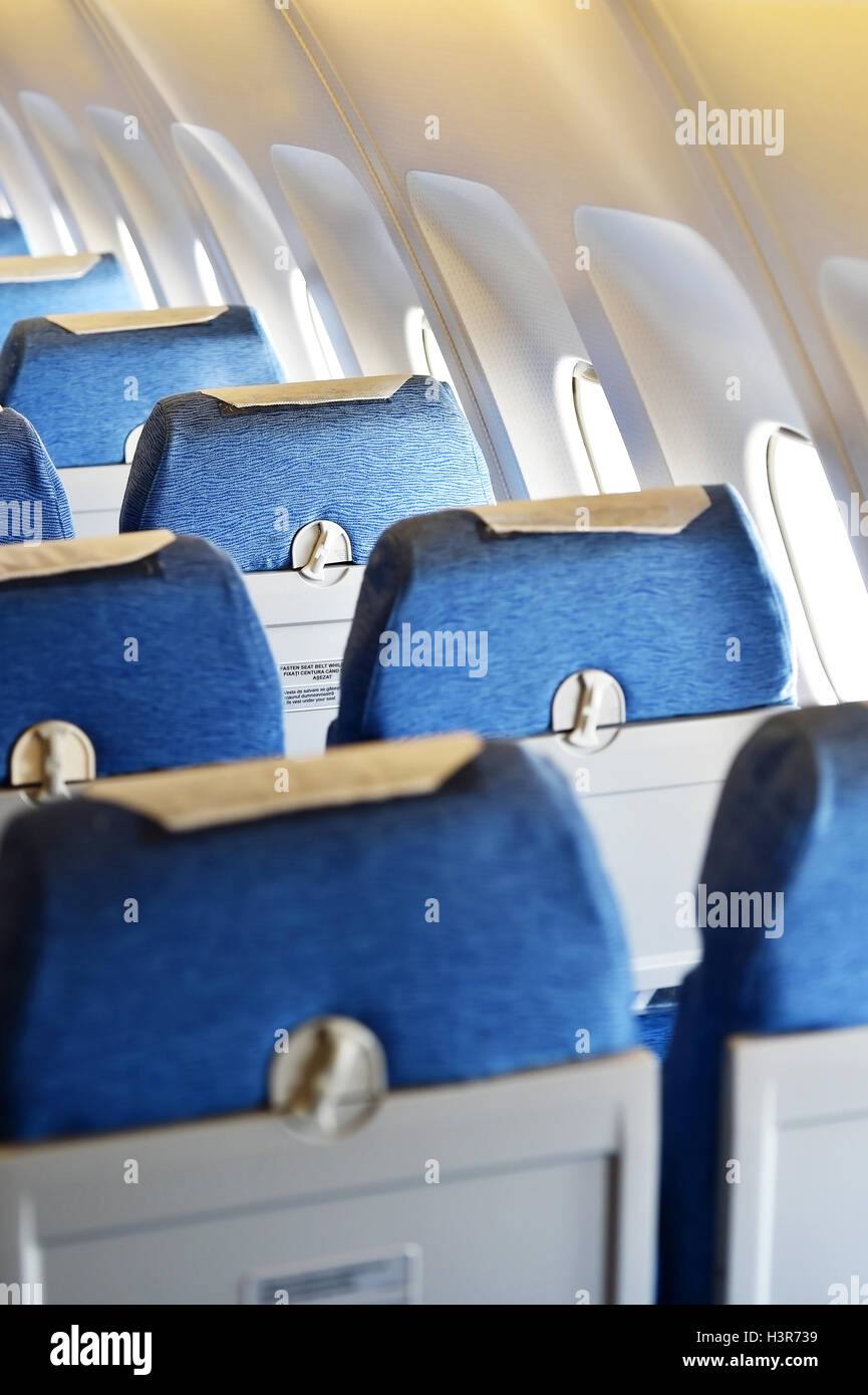 Blue airplane empty seats with new head rest covers Stock Photo