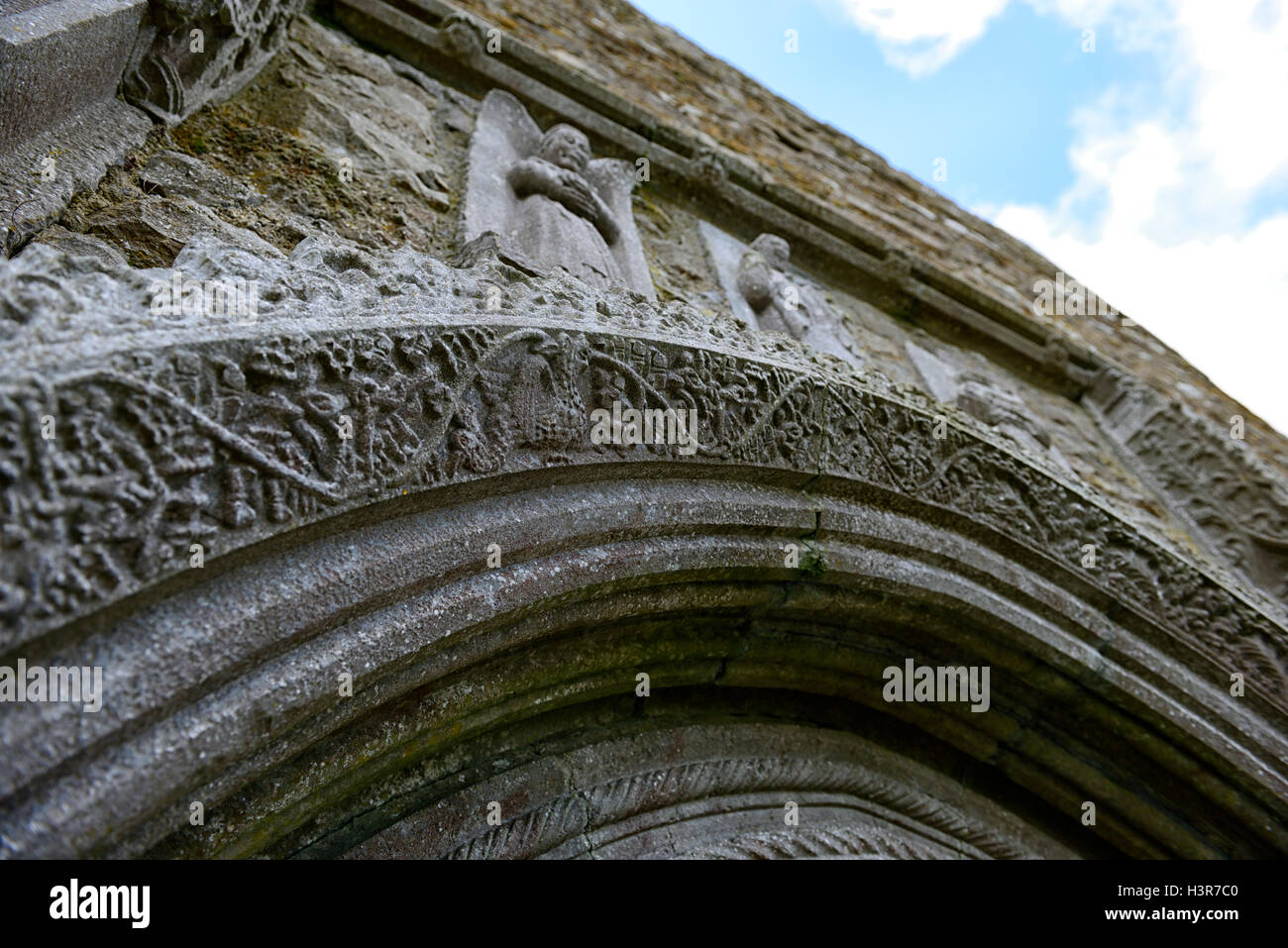 Clonmacnoise ornate stone doorway arch monastic settlement carved stone monument religion religious Monastery Offaly RM Ireland Stock Photo