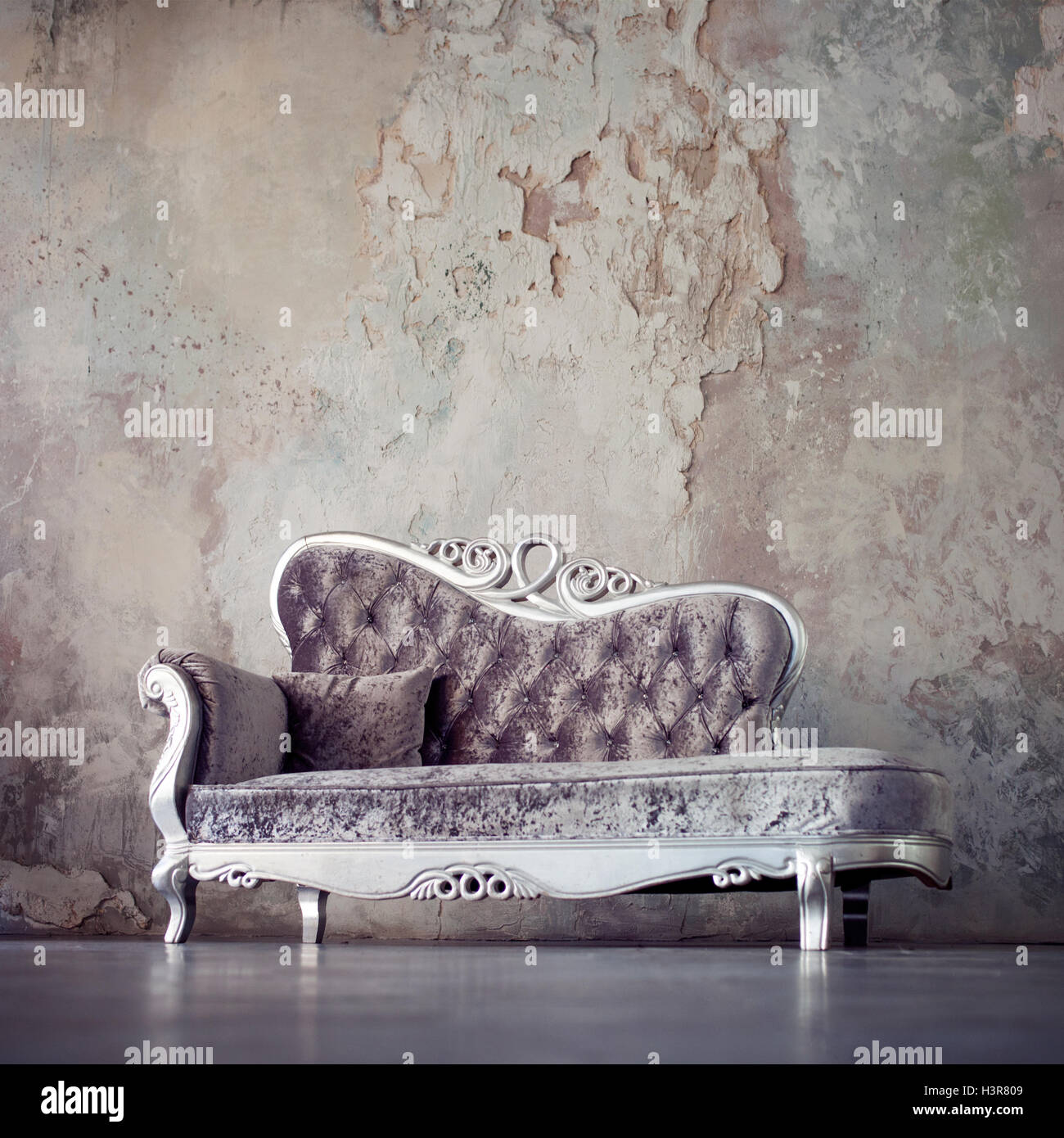 Beautiful sofa in classical style on a background of textured walls Stock  Photo - Alamy