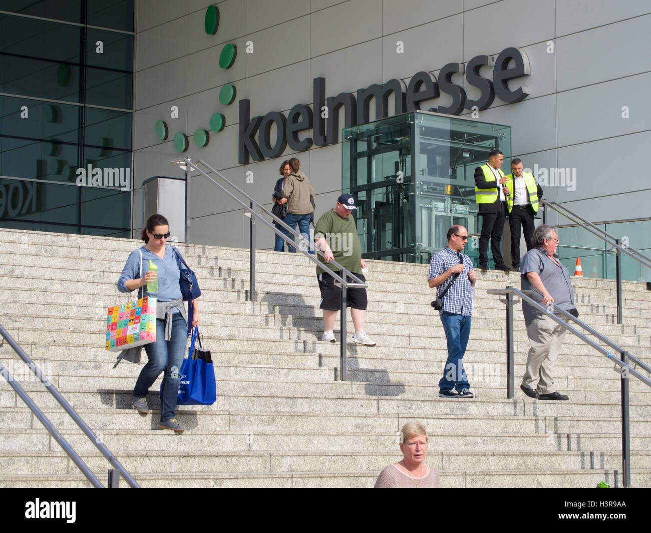 Koeln Messe entrance name sign steps with people in Cologne, Germany Stock Photo