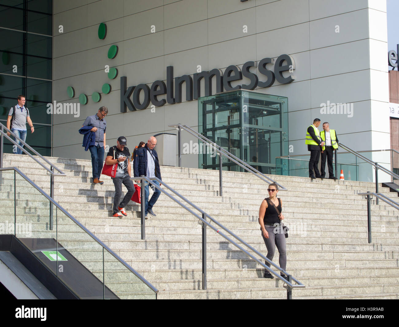 Koeln Messe entrance name sign steps with people in Cologne, Germany Stock Photo